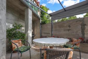 a patio with a white table and chairs at Apartman Vito in Bakar