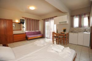 A bed or beds in a room at Stavroula Hotel Palace