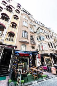 a store with tables and chairs in front of a building at 1st FLOOR APARTMENT İN TAKSİM NEAR İSTİKLAL STREET in Istanbul