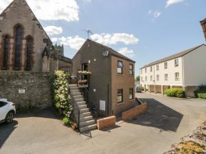 a church with stairs leading up to a building at Muddy Boots - Scarpa in Kirkby Stephen