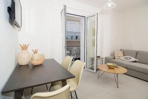 a living room with a table and chairs and a couch at G&K House View in Messini