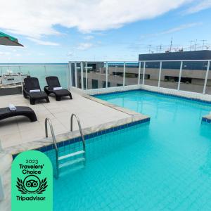 a swimming pool on top of a building at Slim Pajuçara by Tropicalis in Maceió