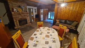 a dining room with a table and chairs and a fireplace at Slovak cottage near Bratislava in the heart of the Carpathians in Modra