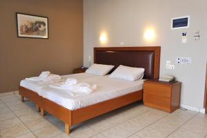 A bed or beds in a room at Stavroula Hotel Palace