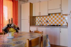A kitchen or kitchenette at Appartamenti Costa - BUDONI SWEET HOME