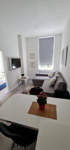 a living room with a couch and a table at Mika Apartment and Studios in Zagreb