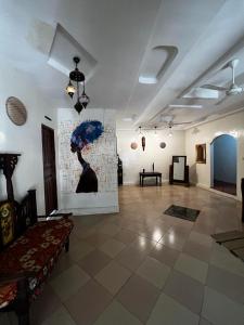 a large room with a painting of a woman with an umbrella at Wakanda Nungwi in Nungwi