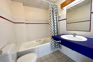 łazienka z umywalką, toaletą i wanną w obiekcie Bright 50 m cocoon with balcony in Combloux w mieście Combloux