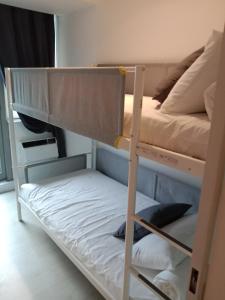 a bunk bed with a ladder next to a bunk bed at Azure Residences by Van Florendo in Manila
