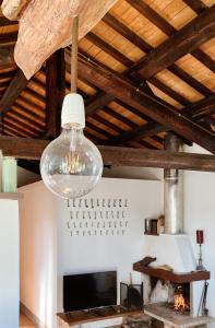 a glass light hanging from a ceiling with a fireplace at Country Loft at Palazzo di Bagnaia in Castel del Piano