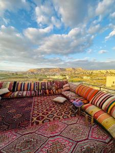 a row of pillows lined up on a carpet at Perla Cappadocia in Göreme