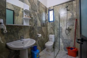 a bathroom with a sink and a toilet and a shower at The Sea House Velipoje in Velipojë