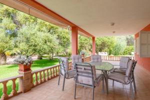 a porch with a table and chairs on it at Luna Azul in Sant Jordi