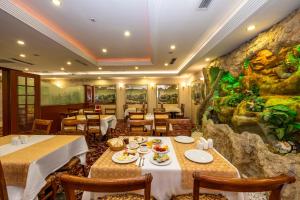 a restaurant with two tables and a rock wall at Grand Anka Hotel in Istanbul