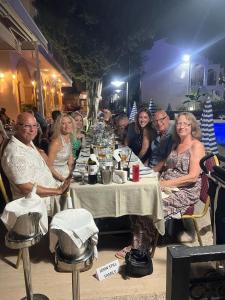 a group of people sitting at a table at Altinkaya Holiday Resort in Kyrenia