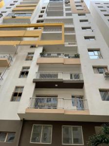 a tall building with balconies on the side of it at Appartement F3 Cité de l’Émergence Dakar Plateau in Dakar