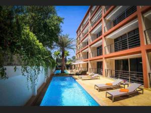 a swimming pool in front of a building at New apartment Rawai Beach 310 by Capital Pro in Phuket