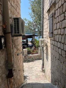 an alley with a fan on the side of a building at Apartman Dado in Perast