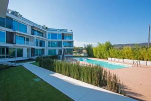 an apartment building with a swimming pool and grass at Bristol Exclusive 2-5 by Wonderful Italy in Lonato del Garda