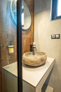 a bathroom with a stone sink on a counter at Kaszubska Lawenda Żuromino, Domek nr 3 in Żuromino