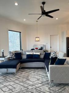 a living room with a couch and a ceiling fan at Amazing New House - Waterfront Getaway + Boat Dock in Dandridge