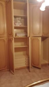 a kitchen with a cupboard with a refrigerator at Casa a Sorso per le tue vacanza in Sorso