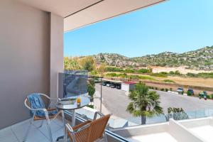 a room with a balcony with a table and chairs at Cathrin Hotel in Faliraki