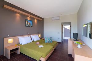a hotel room with a bed and a television at Cathrin Hotel in Faliraki