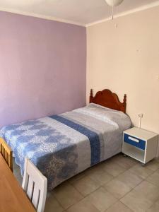 a bedroom with a large bed and a table at Apartamento Playa de Almería - Playa del Zapillo 2 in Almería