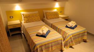 A bed or beds in a room at Il giardino dei tramonti