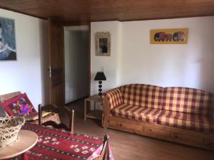 a living room with a couch and a table at Bernex(74) Appartement 4 personnes dans chalet vue imprenable in Bernex