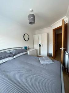 a bedroom with a large bed with a blue comforter at Apt 5a Central by river 1 Bed Apartment in Norwich