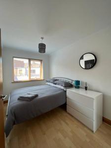 a bedroom with a bed and a dresser and a mirror at Apt 5a Central by river 1 Bed Apartment in Norwich