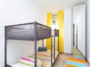 a room with two bunk beds and a mirror at Live Inglaterra Medano Beach in El M&eacute;dano