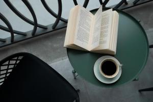 un livre sur une table avec une tasse de café dans l'établissement RIS Holiday Apartments Tsaghkadzor, à Tsaghkadzor