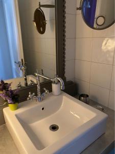 a white sink in a bathroom with a mirror at B&B Binot in Carmagnola