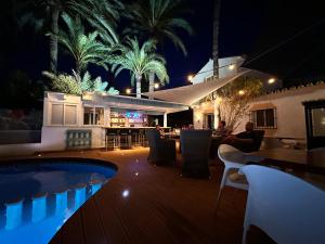 a resort with a pool and a restaurant at night at Banus Lodge in Marbella