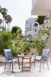 two chairs and a table on a patio at Mary's Maisonette in Kos