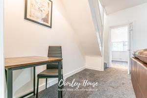 a dining room table and chairs in a tiny house at Chorley Contractor Accommodation in Chorley