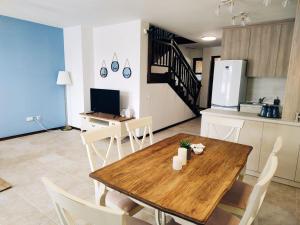 a kitchen and dining room with a wooden table and chairs at Sozopolis Holiday Village in Sozopol