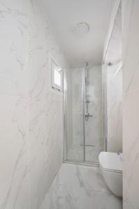 a white bathroom with a shower and a toilet at Cute Charming 1bed1bath Bebek Hidden Gem! #77 in Istanbul