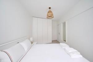 a white bedroom with a bed and a pendant light at Bright Modern New 1bed1bath Hidden Gem Bebek! #78 in Istanbul