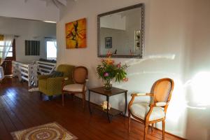 a living room with chairs and a mirror on the wall at The Milligan in Kingstown