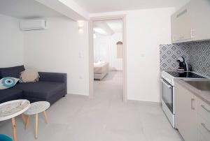 a kitchen and a living room with a couch at G&K House Garden in Messini