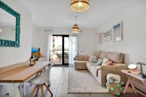 a living room with a couch and a table at 2 terraces apartment w/ astonishing views. in Costa de Antigua