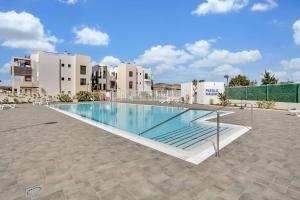 an image of a swimming pool at a resort at 2 terraces apartment w/ astonishing views. in Costa de Antigua