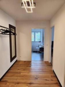an empty room with a hallway with a wooden floor at Ferienwohnung am Goitzschesee in Pouch