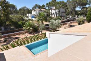 an aerial view of a house with a swimming pool at Villa Chalet Porto Petro in Portopetro