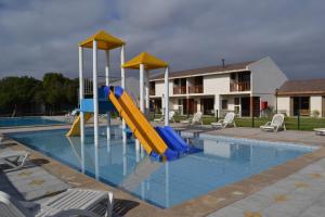 a swimming pool with a slide in the middle of it at Cabañas Las Añañucas V in La Serena