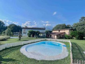 a house with a large swimming pool in the yard at El Bosque de Candeleda in Candeleda